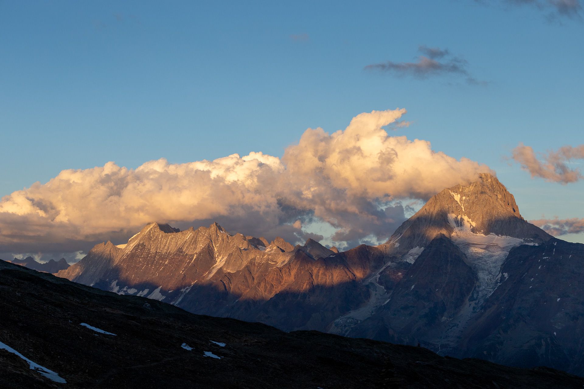 The evening sun illuminating the ***Bietschhorn***, as seen from the terrace of the ***Lötschenpasshütte***.